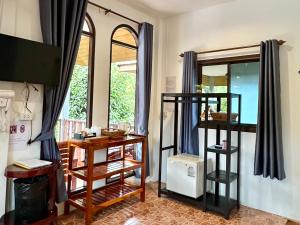 a room with a mirror and a table with shelves at Khao Sok Jungle Huts Resort in Khao Sok National Park
