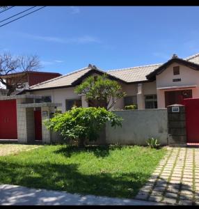 a house with a fence and a yard at 海軍官邸眷村民宿 in Nan-men
