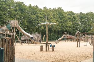 a playground with a slide in the sand at Ferienpark Grafschaft Bentheim in Uelsen +53 photos