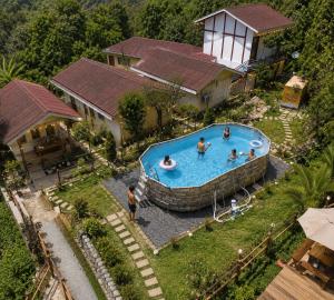 an overhead view of a swimming pool in a house at Skywood by Vankuteer - Pool & Mountain view Rooms in Kandāghāt