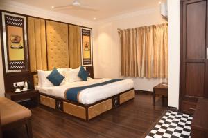 a hotel room with a bed in a room at Belair Suites in Pune
