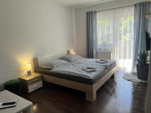 a bedroom with a bed with two towels on it at Vilka Čachtice in Čachtice