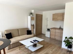 a living room with a couch and a table at Vilka Čachtice in Čachtice