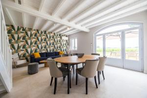 a dining room with a table and chairs at La Maison Blanche in Saint-Sulpice-de-Faleyrens