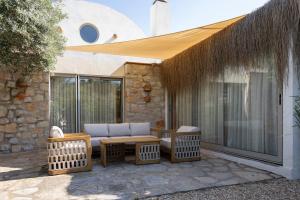 a patio with a couch and a table and chairs at Odette Pansiyon Bodrum in Bodrum City
