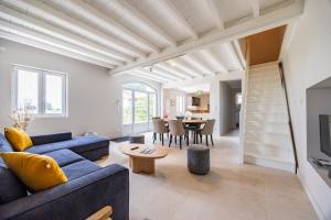 a living room with a blue couch and a table at La Maison Blanche in Saint-Sulpice-de-Faleyrens
