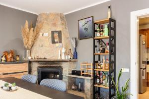 a living room with a fireplace and blue chairs at Villa Toro in Maçanet de la Selva