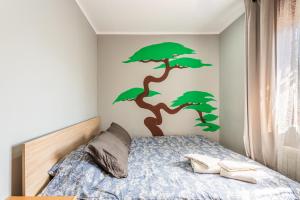 a bedroom with a bed with a tree on the wall at Villa Toro in Maçanet de la Selva +28 photos