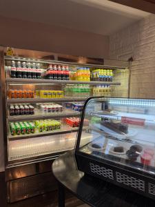 a refrigerator filled with lots of different types of food at The Queens Road Hotel in Isle of Wight