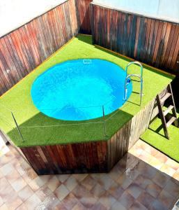 a large swimming pool with grass around it at Gandia Confort Treviso in Gandía