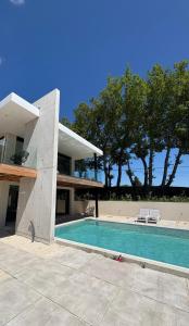 a swimming pool in front of a house at Villa Loka-Ecrin contemporain Adult only in Sauzet