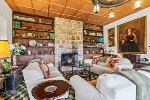 a living room with couches and a stone fireplace at La casona de La Garaba in Grado