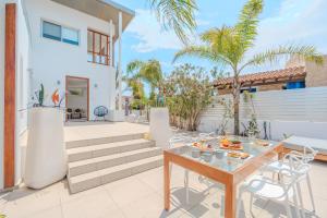a patio with a table with food on it at Seaside Hideaway Villa in Perivolia