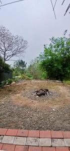 a yard with a pile of dirt and trees at Roamwander APARTMENT in Vagamon