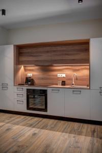 a kitchen with a sink and a stove at La VILLA DELLE TORRI in Ermoupoli