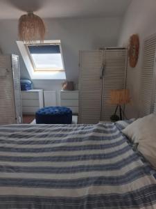 a bedroom with a large bed and a window at Maison ensoleillée plage a pied in Houlgate