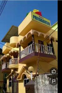 a yellow building with a balcony on top of it at priyadarshi in Digha
