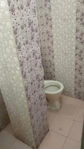 a bathroom with a toilet in a shower stall at priyadarshi in Digha