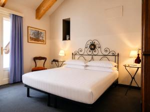 a bedroom with a large white bed and a window at Phi Hotel Palio in Asti +58 photos