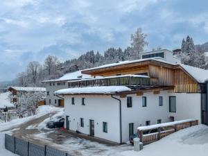 a building with snow on top of it at Ferienwohnung Heissl in Fieberbrunn