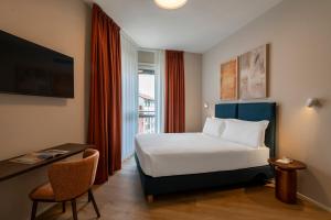 a hotel room with a bed and a window at RELSTAY - Vercelli Suites in Milan
