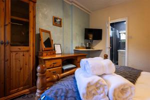 a bedroom with a bed with towels on it at Strands Hotel/Screes Inn & Micro Brewery in Nether Wasdale
