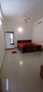 a bedroom with two beds and a ceiling fan at Roamwander APARTMENT in Vagamon +2 photos