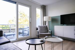a living room with a couch and a table at Waddenhuyske in Hollum