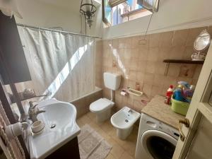 a small bathroom with a sink and a toilet at Casa San Francesco in Agnone +27 photos