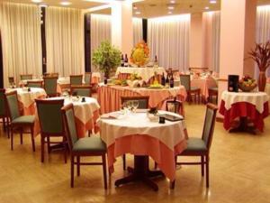 a dining room with tables and chairs and tablesktop at Hotel Executive Meeting & Events in Udine