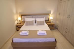 a bedroom with a bed with two towels on it at Villa Thea, By IdealStay Experience in Kaloi Limenes