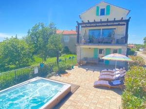 a house with a swimming pool in front of a house at Villa Gisella in Nedeščina