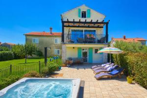 a villa with a swimming pool and a house at Villa Gisella in Nedeščina