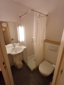 a bathroom with a sink and a toilet and a shower at Hôtel Toulouse Labège in Labège
