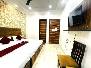 a hotel room with a bed and a tv at Hotel Embassy In - 200 Mtrs - Near Golden Temple in Amritsar