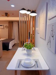 a white table with plates on it in a room at Gabbys Place in Bacolod
