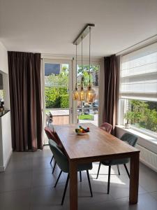 a dining room with a wooden table and chairs at Vakantiewoning Yerseke in Yerseke