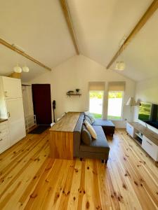 a bedroom with a large bed in a room with wooden floors at Rest-Inn Timber-Lake in Kłodno +12 photos