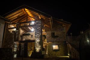 ein Steinhaus in der Nacht mit Lichtern in der Unterkunft Souvenir De Tsaneli in Roisan