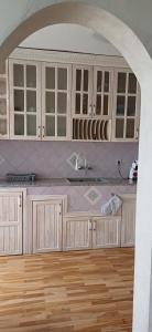 a kitchen with white cabinets and a counter top at Шанс in Velingrad