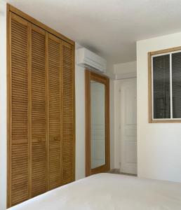 a bedroom with a bed and a closet at Chambre 2 dans un petit paradis in La Londe-les-Maures