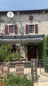 a building with a bunch of plants in front of it at Istria Stone House in Marasi