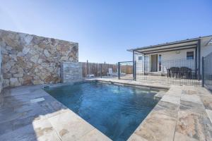 a swimming pool in front of a house at Bungalow Tranquilo Cerca de Roche in Conil de la Frontera