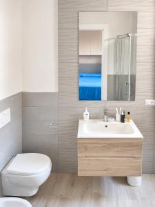 a bathroom with a sink and a toilet and a mirror at Approdo del Re in Grottammare +10 photos