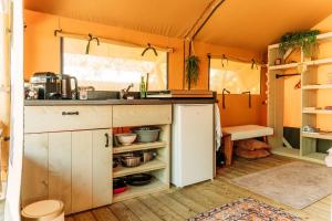 an interior view of a kitchen in a tent at SoulSafari aan Zee in Julianadorp