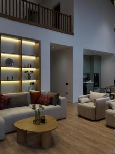 a living room with two couches and a table at escape gabala in Vǝndam