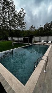 a large swimming pool in a yard with chairs at escape gabala in Vǝndam