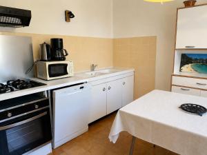 a kitchen with a sink and a microwave at Casa Minnana in Figari