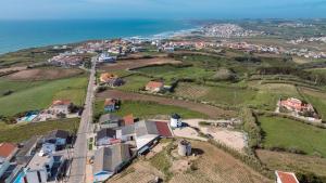 an aerial view of a village and the ocean at Villa Atlantica One Sea View - Pool - Sunset in Lourinhã +32 photos
