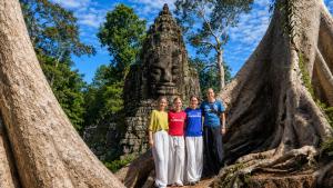 a group of women standing in front of a statue at LOTUS SERENITY Hostel in Siem Reap